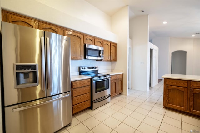 kitchen featuring light tile patterned floors and stainless steel appliances