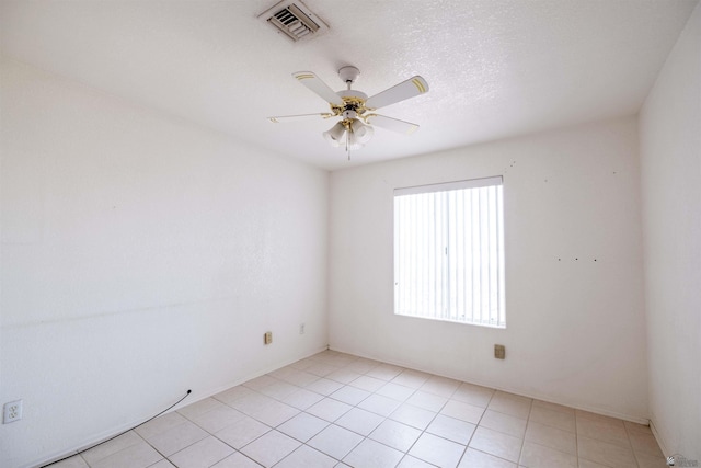 unfurnished room featuring light tile patterned flooring, ceiling fan, and a textured ceiling