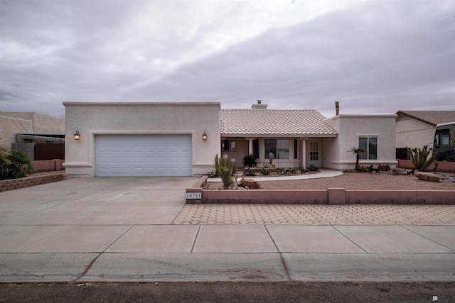 pueblo-style home featuring a garage