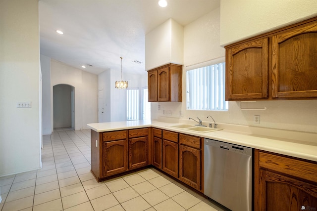 kitchen with pendant lighting, dishwasher, sink, light tile patterned floors, and kitchen peninsula