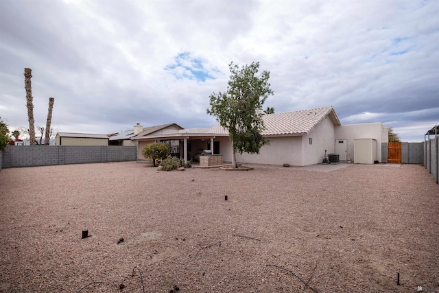 rear view of property featuring a patio and cooling unit