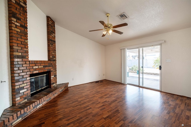 unfurnished living room featuring ceiling fan, dark hardwood / wood-style floors, a textured ceiling, and a fireplace