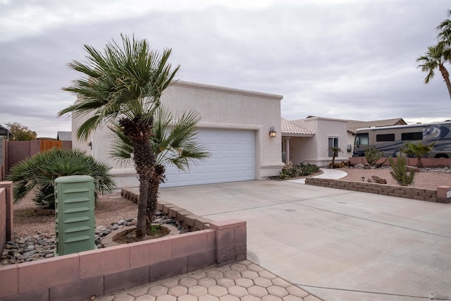 pueblo-style house featuring a garage