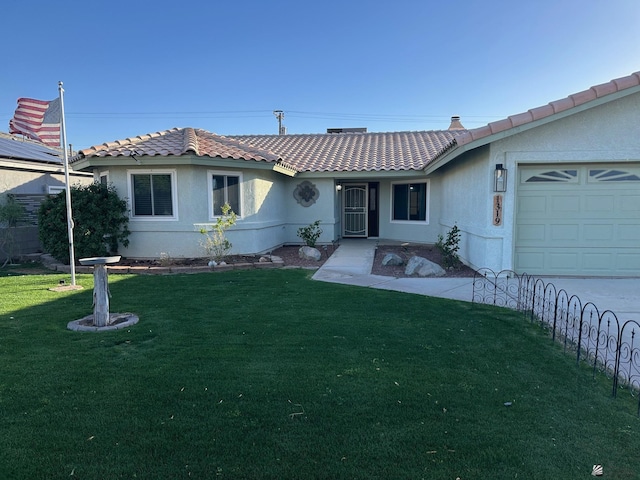 view of front facade featuring a front yard and a garage