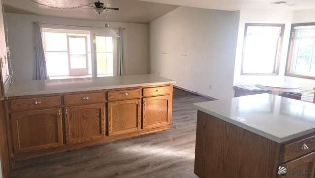 kitchen featuring ceiling fan, dark hardwood / wood-style flooring, and a kitchen island