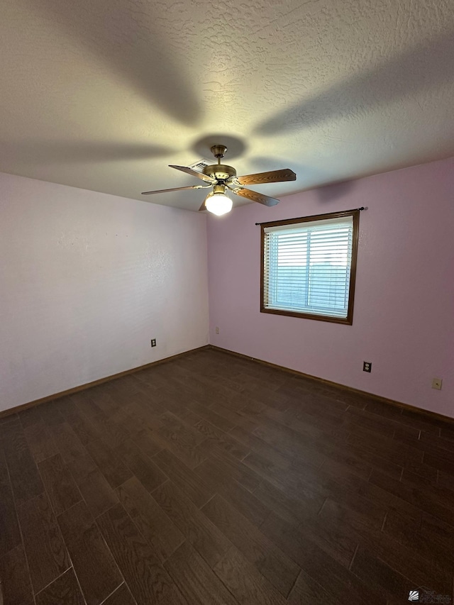 unfurnished room featuring a textured ceiling, dark wood-type flooring, and ceiling fan