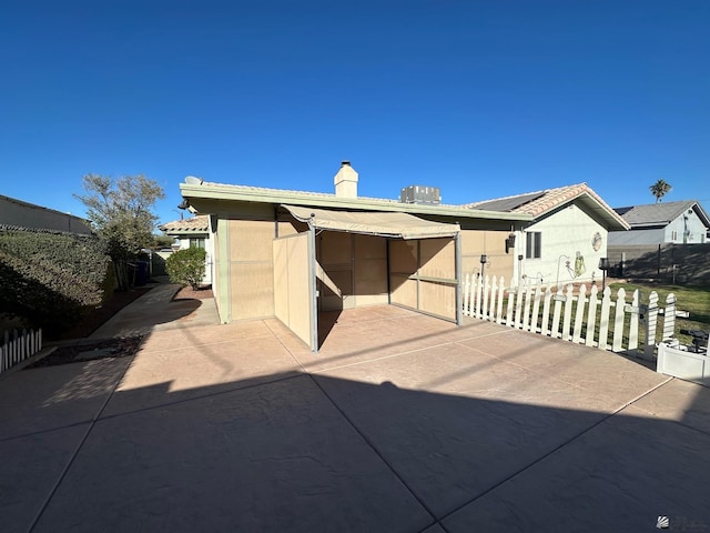 rear view of property featuring a patio area