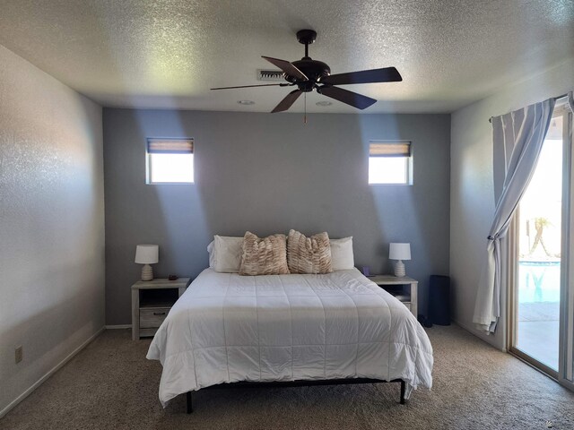 bedroom with carpet flooring, access to exterior, ceiling fan, and multiple windows