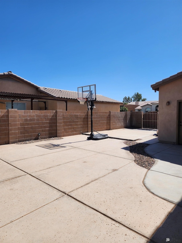 view of patio featuring basketball hoop