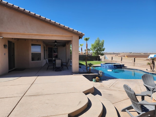 view of pool featuring a patio area, an in ground hot tub, and ceiling fan