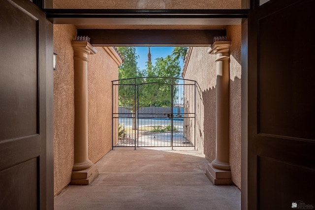 doorway to outside featuring decorative columns