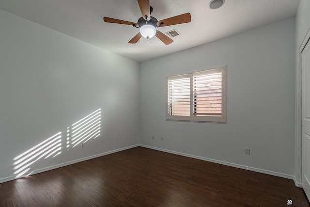 unfurnished room with dark hardwood / wood-style flooring and ceiling fan