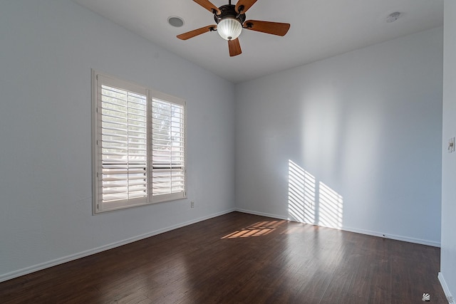 empty room featuring dark hardwood / wood-style floors and ceiling fan