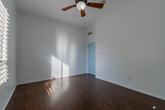 spare room featuring ceiling fan and dark wood-type flooring