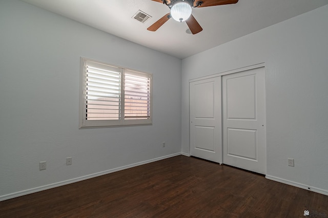 unfurnished bedroom with a closet, ceiling fan, and dark wood-type flooring