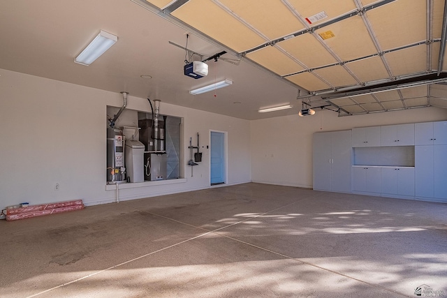 garage featuring strapped water heater and a garage door opener