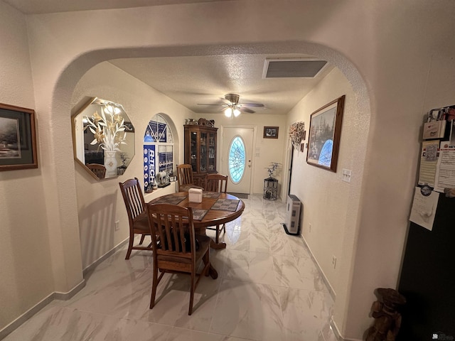 dining room featuring a textured ceiling and ceiling fan