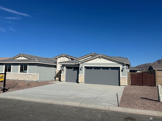 view of front of property with a mountain view and a garage