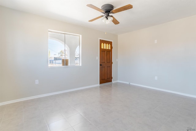 tiled empty room with ceiling fan