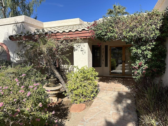 doorway to property with a patio area and french doors