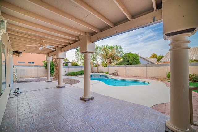 view of swimming pool featuring a patio area, a fenced backyard, a pool with connected hot tub, and ceiling fan