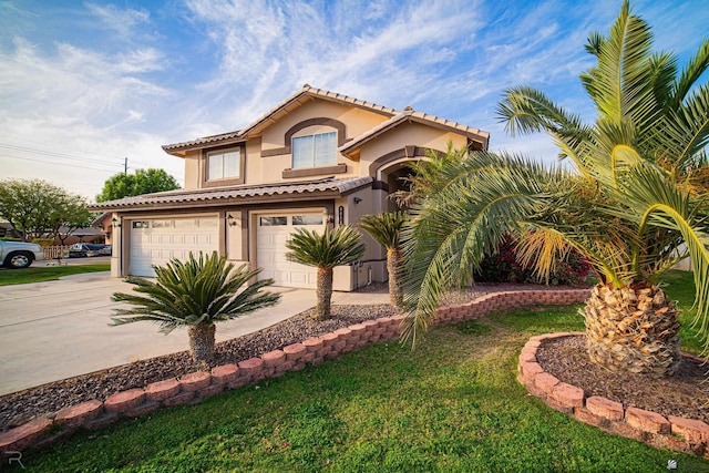 mediterranean / spanish-style house with an attached garage, a tile roof, concrete driveway, and stucco siding