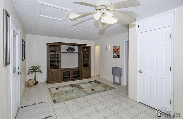 interior space with ceiling fan and light tile patterned flooring