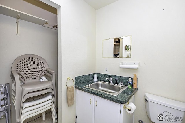 bathroom featuring tile patterned flooring, vanity, and toilet