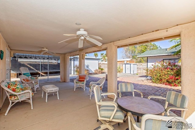 view of patio / terrace featuring ceiling fan and a shed