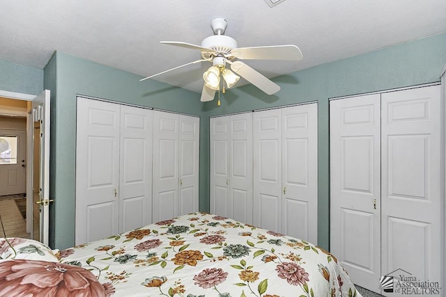 bedroom featuring two closets and ceiling fan