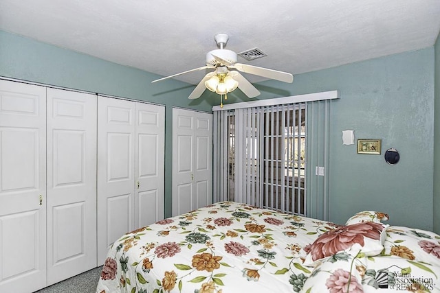 bedroom with multiple closets and ceiling fan