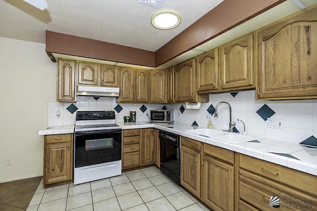 kitchen with sink, dishwasher, white electric range, tile counters, and light tile patterned flooring