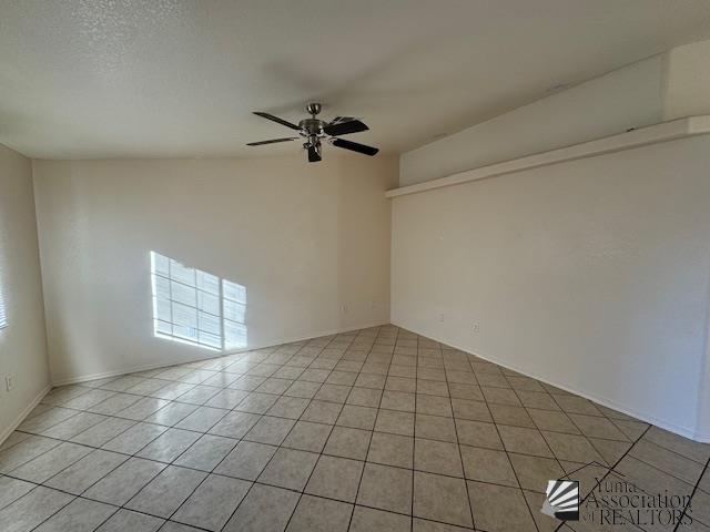 tiled spare room featuring ceiling fan and a textured ceiling