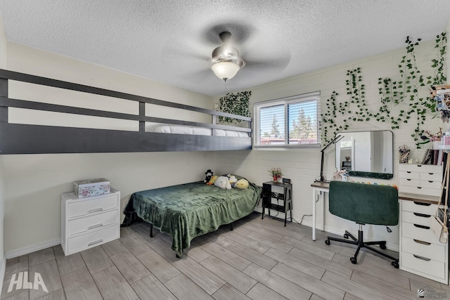 bedroom featuring a textured ceiling and wood tiled floor