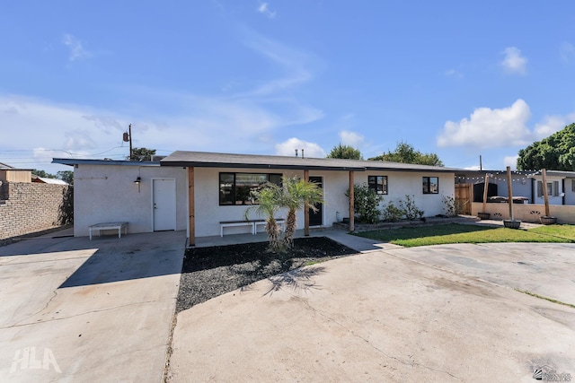 ranch-style home with fence and stucco siding