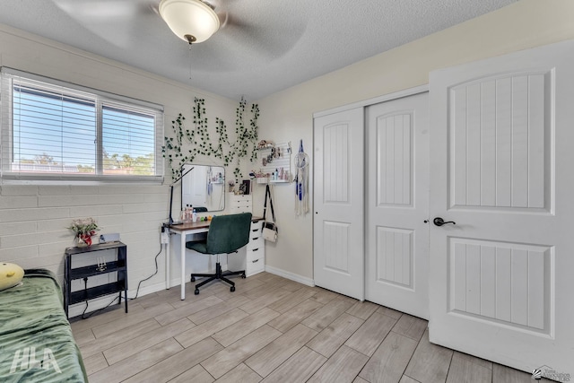 office space featuring a textured ceiling and wood tiled floor