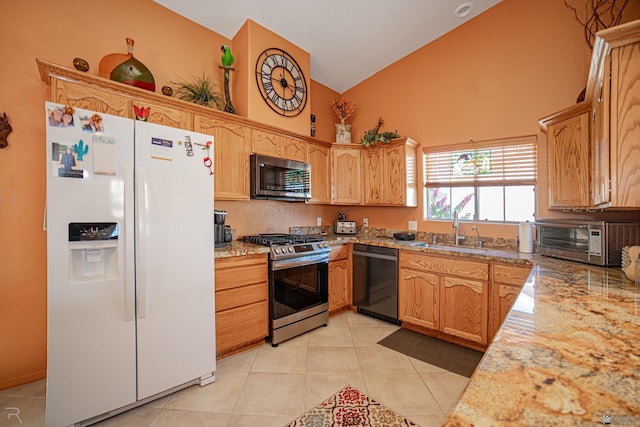 kitchen with appliances with stainless steel finishes, light stone counters, sink, high vaulted ceiling, and light tile patterned flooring