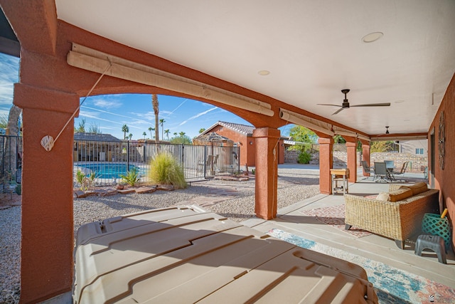 view of patio / terrace featuring a fenced in pool and ceiling fan