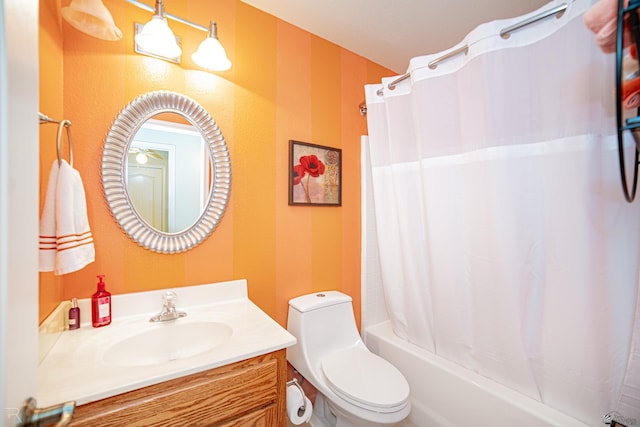 full bathroom featuring vanity, toilet, and shower / tub combo with curtain