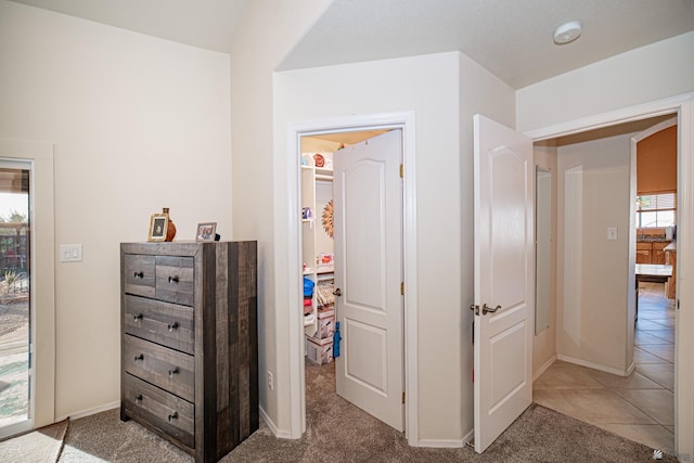 hall with light colored carpet