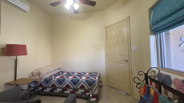 bedroom with a wall mounted air conditioner, ceiling fan, and light tile patterned floors