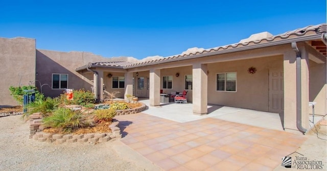 rear view of house featuring a patio