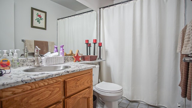 bathroom with tile patterned flooring, vanity, and toilet