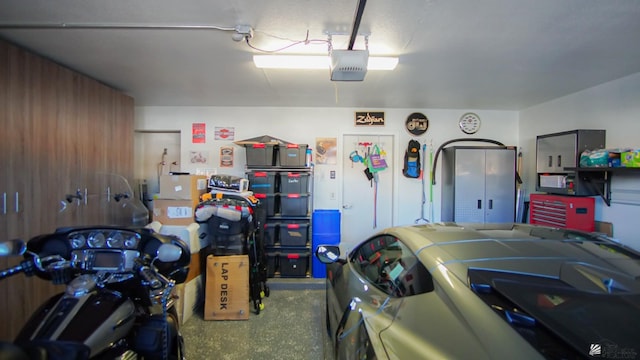 garage featuring wooden walls and a garage door opener