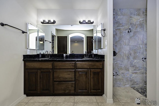 bathroom featuring tile patterned floors, vanity, and a shower