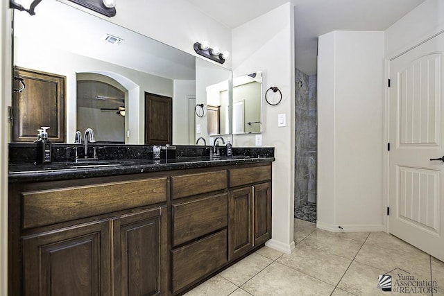 bathroom with tile patterned floors, ceiling fan, vanity, and walk in shower