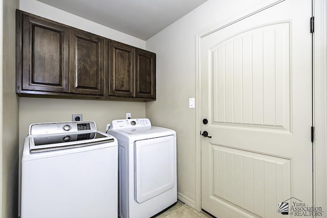 clothes washing area featuring cabinets, independent washer and dryer, and light tile patterned floors