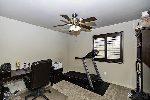 carpeted office space with ceiling fan