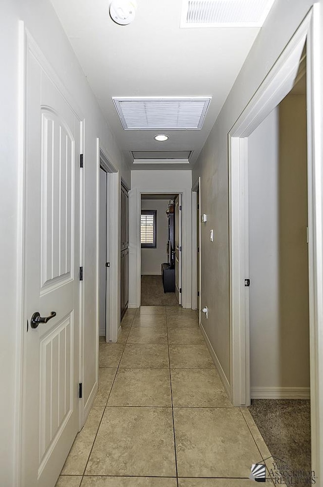 corridor featuring light tile patterned floors