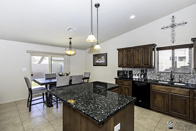 kitchen featuring dishwasher, sink, hanging light fixtures, dark stone counters, and a kitchen island